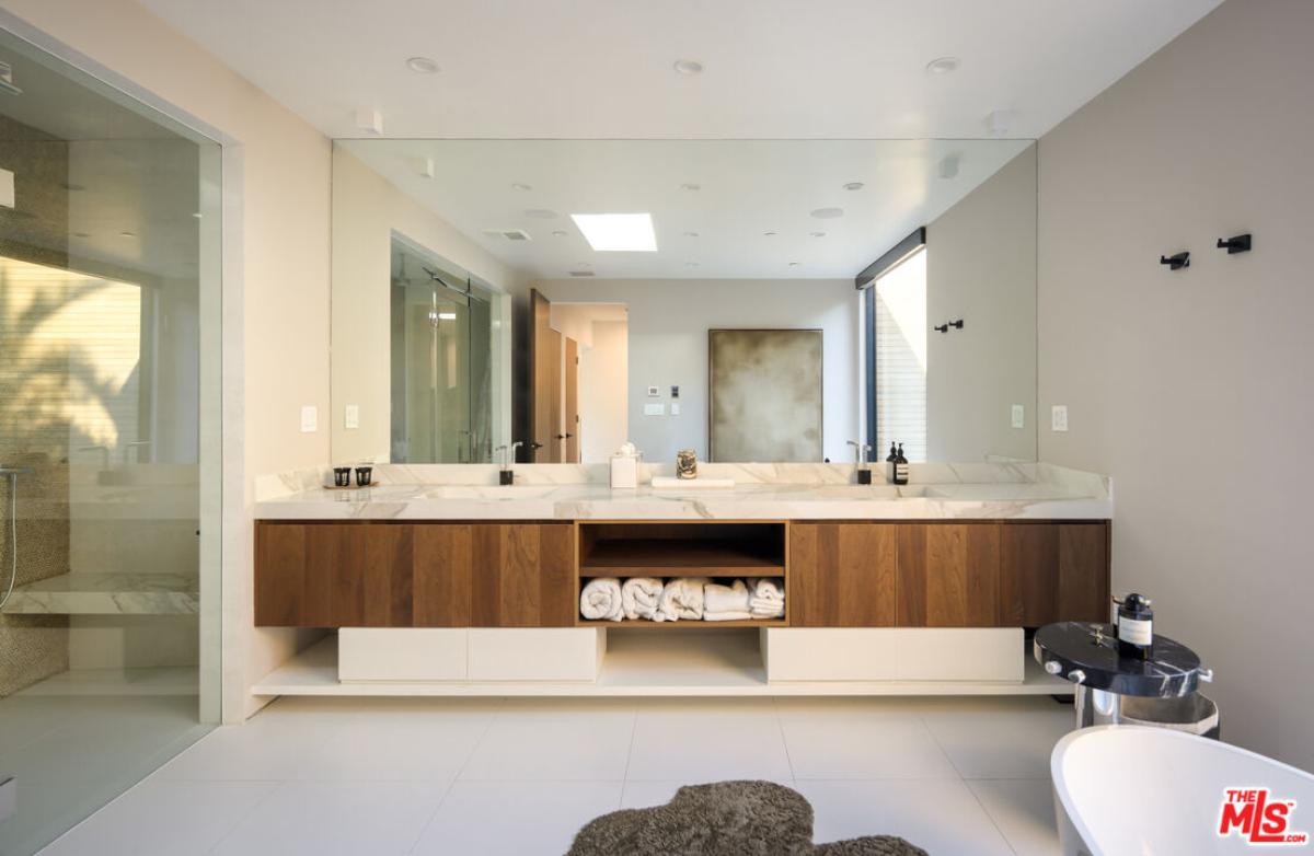 Bathroom with a custom-made vanity and a walk-in shower.