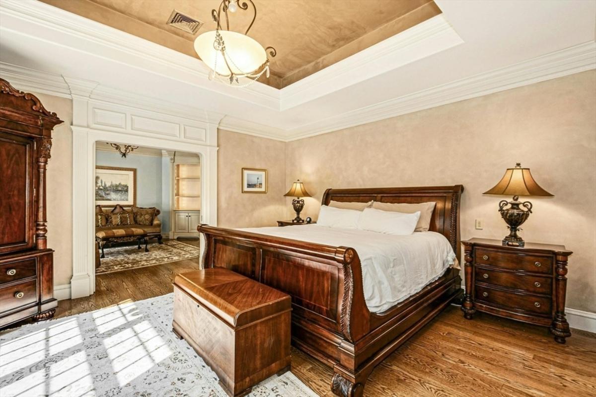Bedroom with a large bed and hardwood floors.