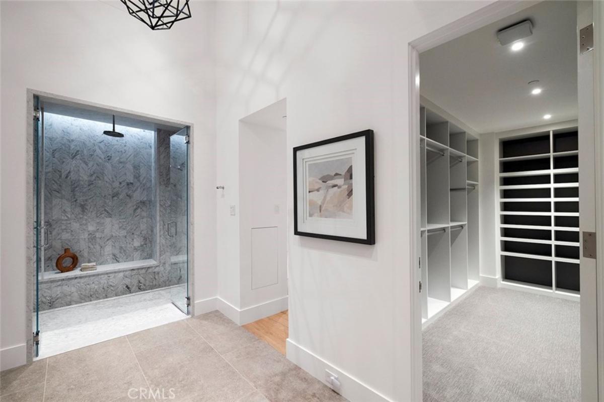 Bathroom with a walk-in shower and a walk-in closet.
