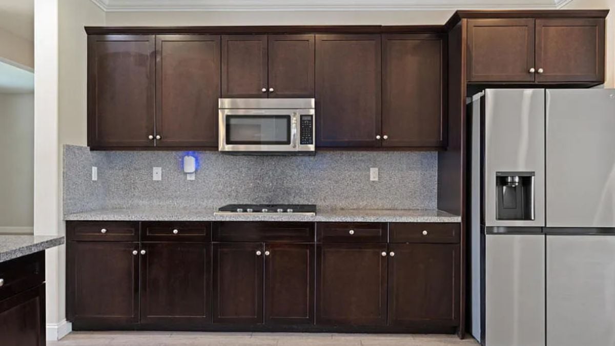 A kitchen with a countertop, cabinets, and kitchen appliances.