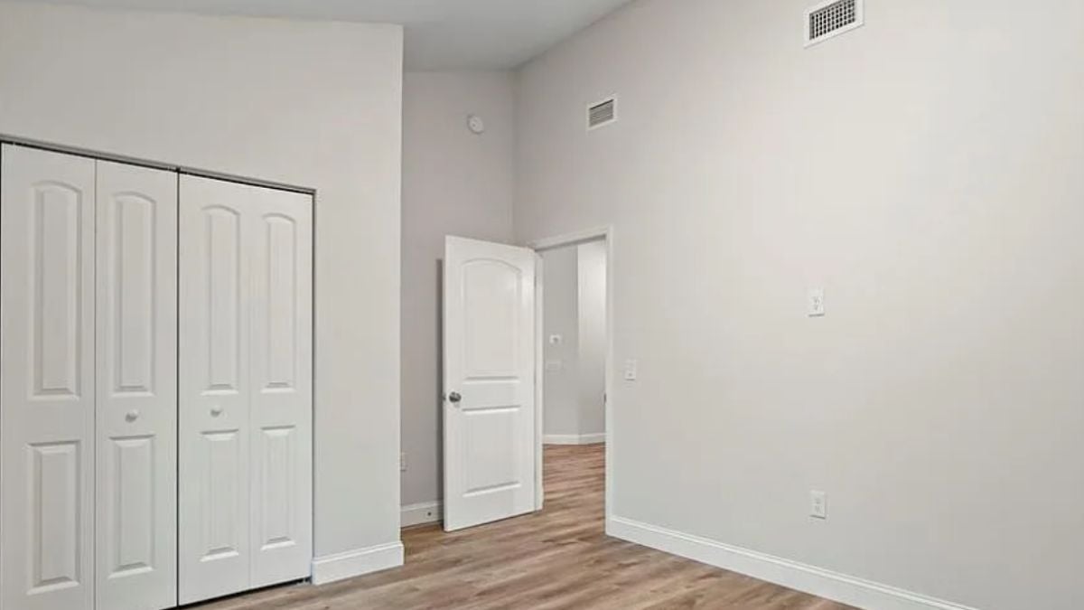 A bedroom with wooden floor.