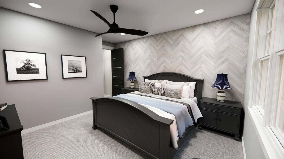 Primary bedroom with black furnishings and a chevron accent wall.
