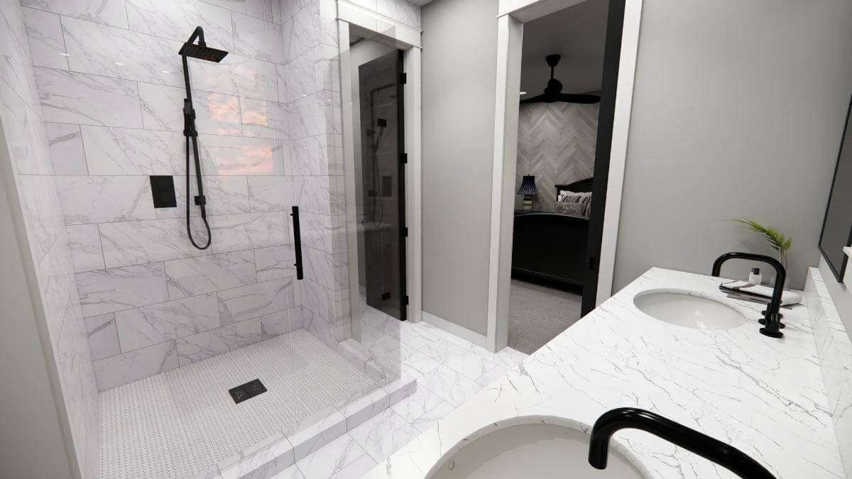 Primary bathroom with a dual sink vanity and a tiled shower.