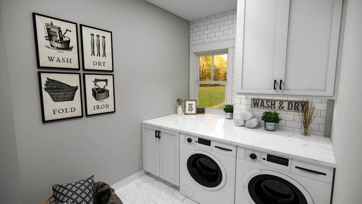 Laundry room with white cabinets and a marble countertop.
