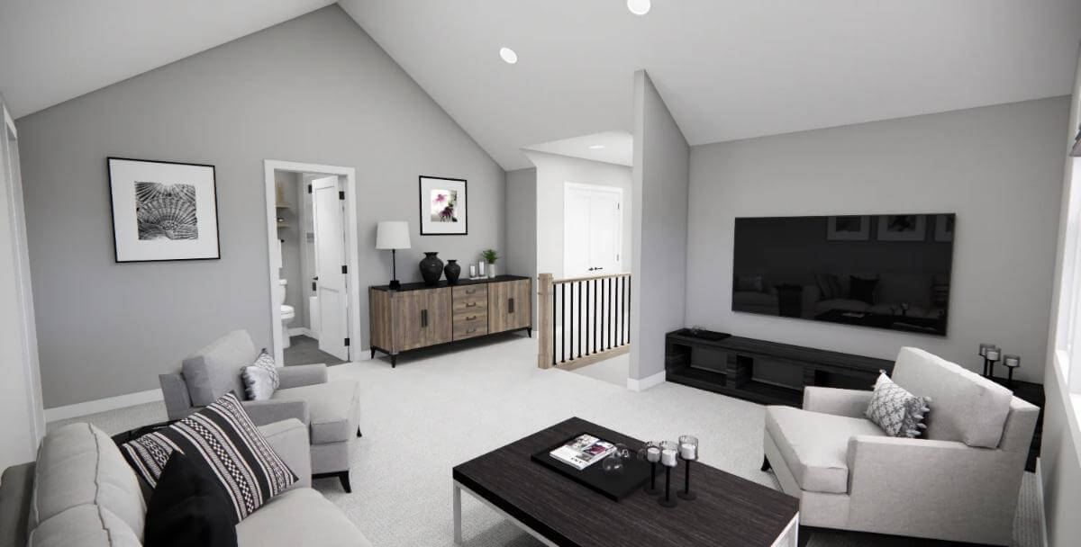 Loft with a wall-mounted TV and gray seats under the cathedral ceiling.