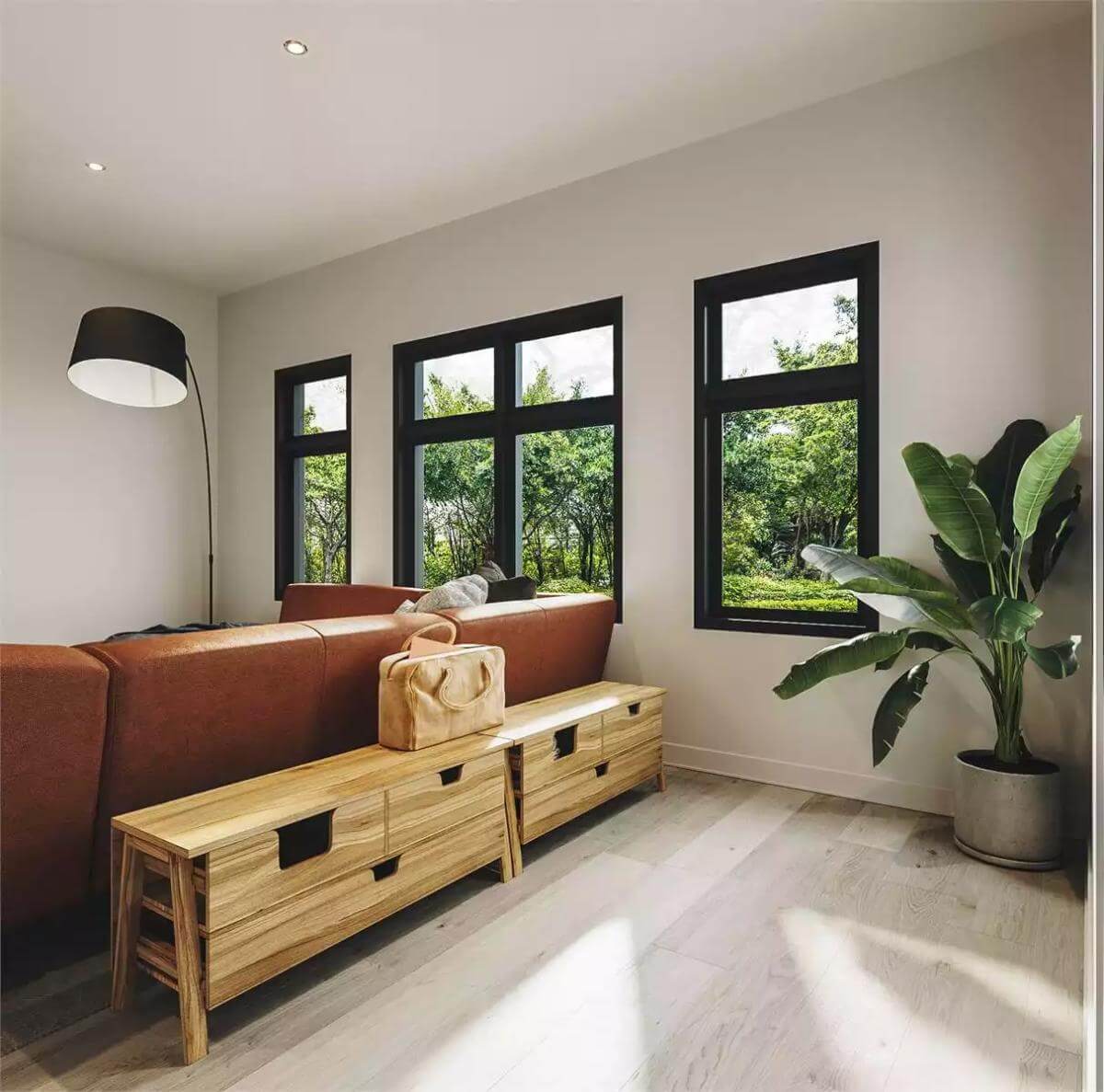 Living room illuminated by an arched floor lamp and black-framed windows.