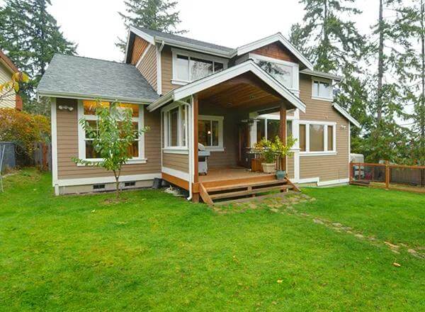 Rear view with clapboard siding and a gabled patio.