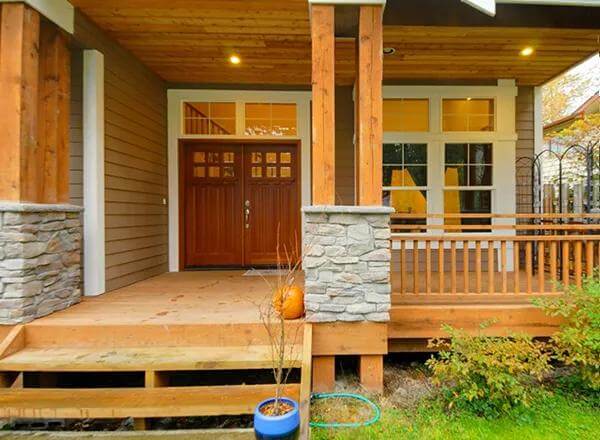 Entry porch with double front doors and a wood-paneled ceiling.