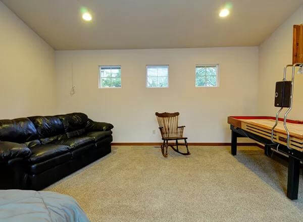 Recreation room with a leather sofa and a billiards table.