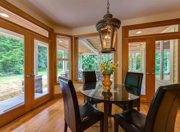 Breakfast nook with a round dining set and outdoor access via French doors.