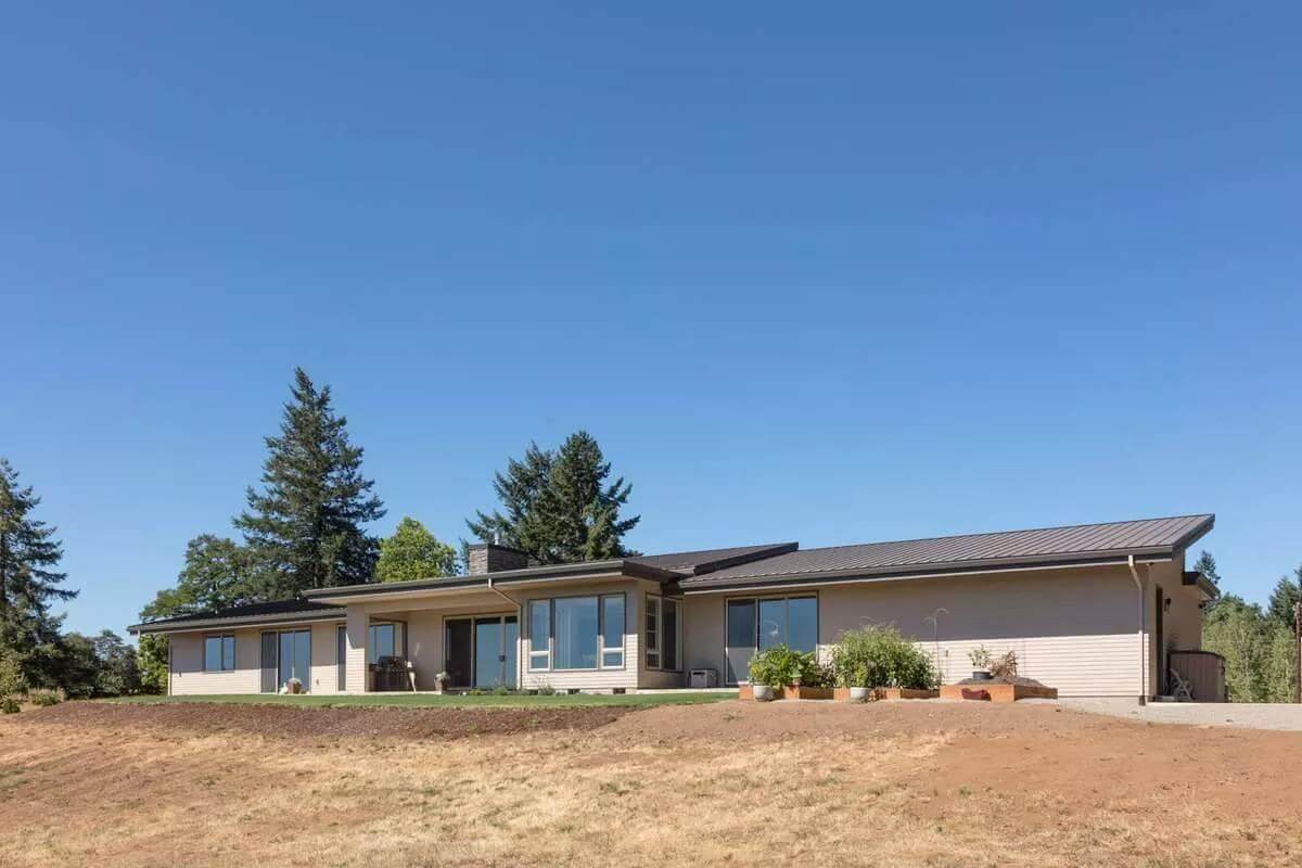 Rear view with huge windows and covered porches.