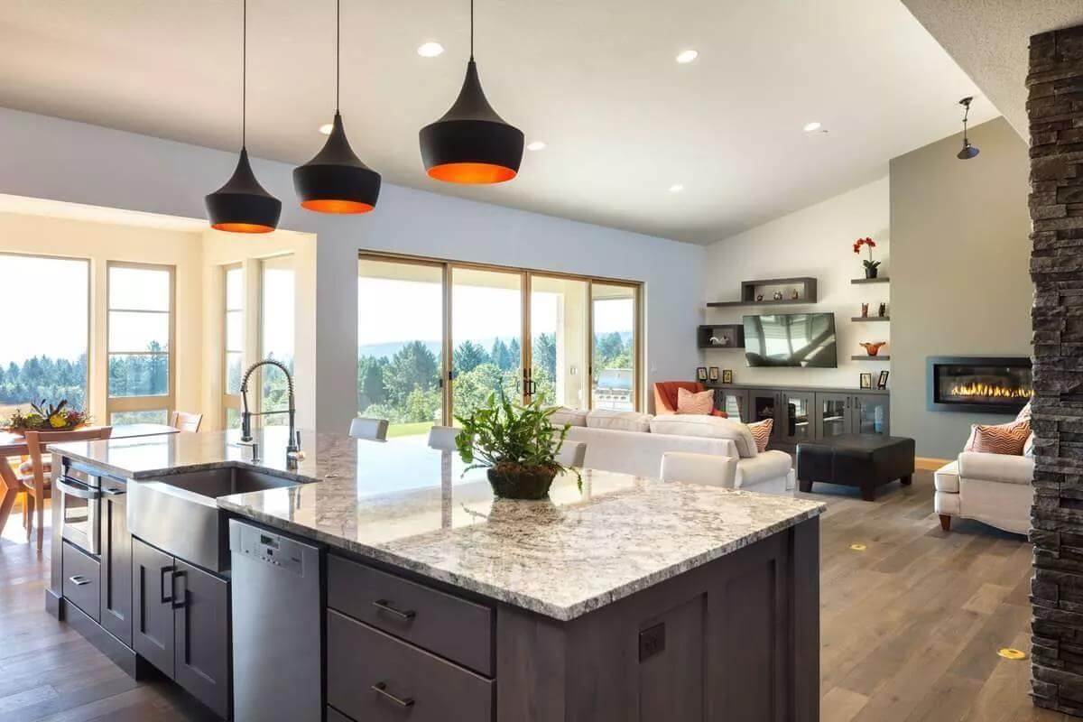 Kitchen island with a farmhouse sink overlooking the great room.