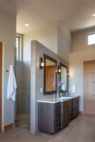 Bathroom with a large vanity and a walk-in shower.