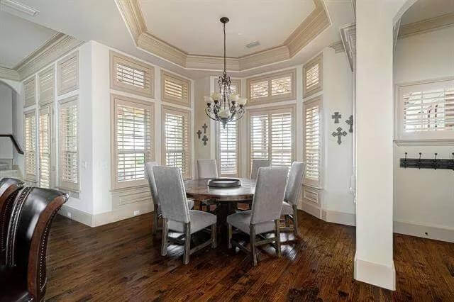 Breakfast nook with a round dining set against the bay window.