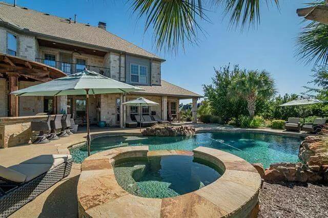 Rear view with a covered lanai and a swimming pool.