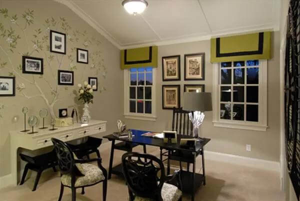 Office with a black desk, a contrasting console table, and a vaulted ceiling.