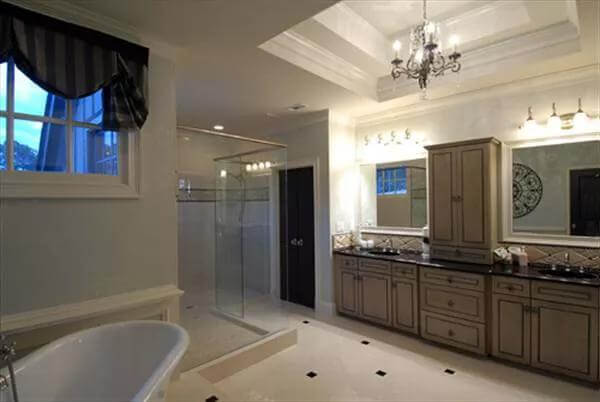 Primary bathroom with a dual sink vanity, a soaking tub, and a walk-in shower. 