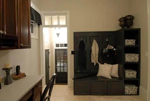 Mudroom with coat hooks and a built-in desk.