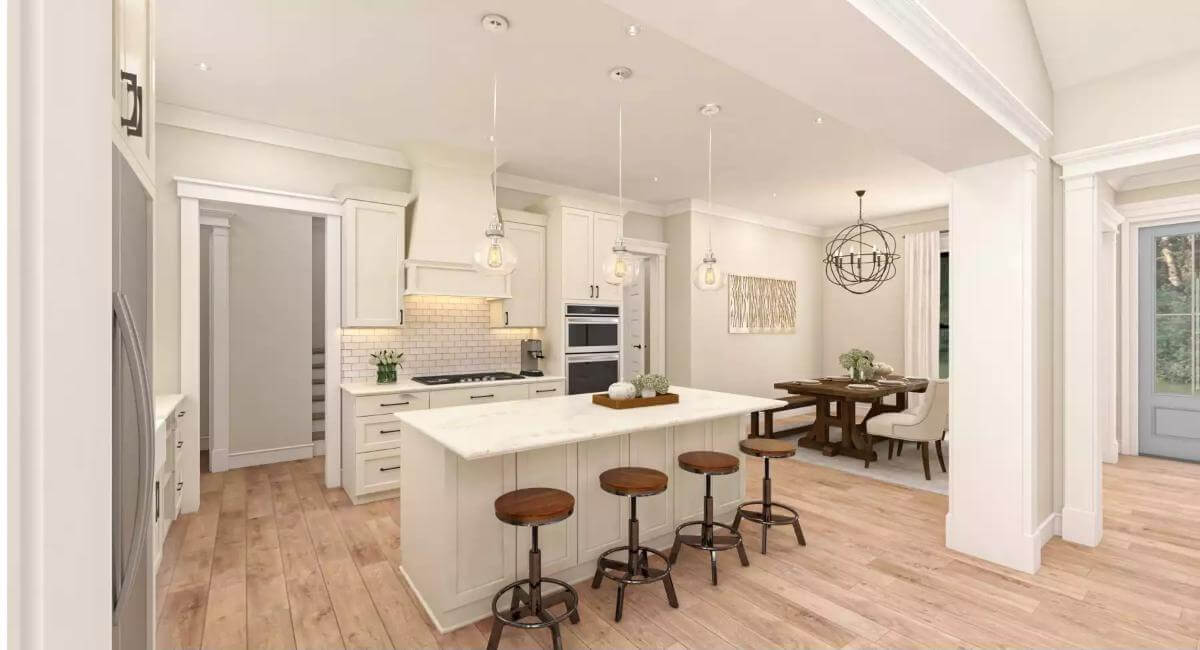 Kitchen with white cabinetry and a matching island paired by round bar stools.