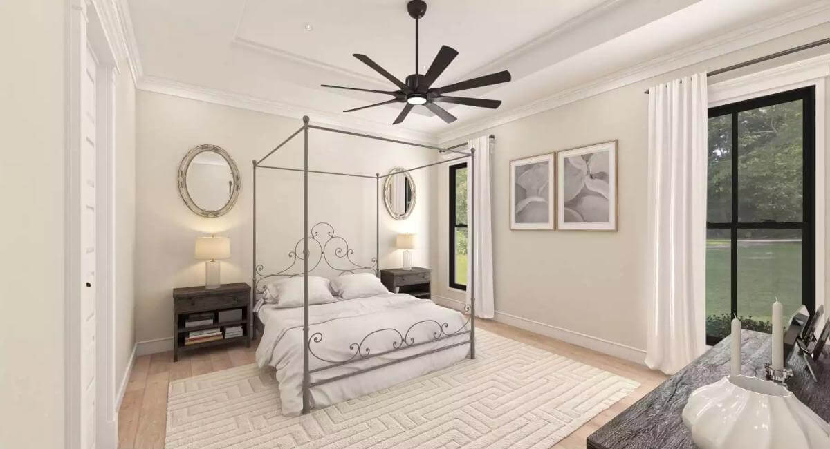 Primary bedroom with a canopy bed and an iron fan mounted on the tray ceiling.