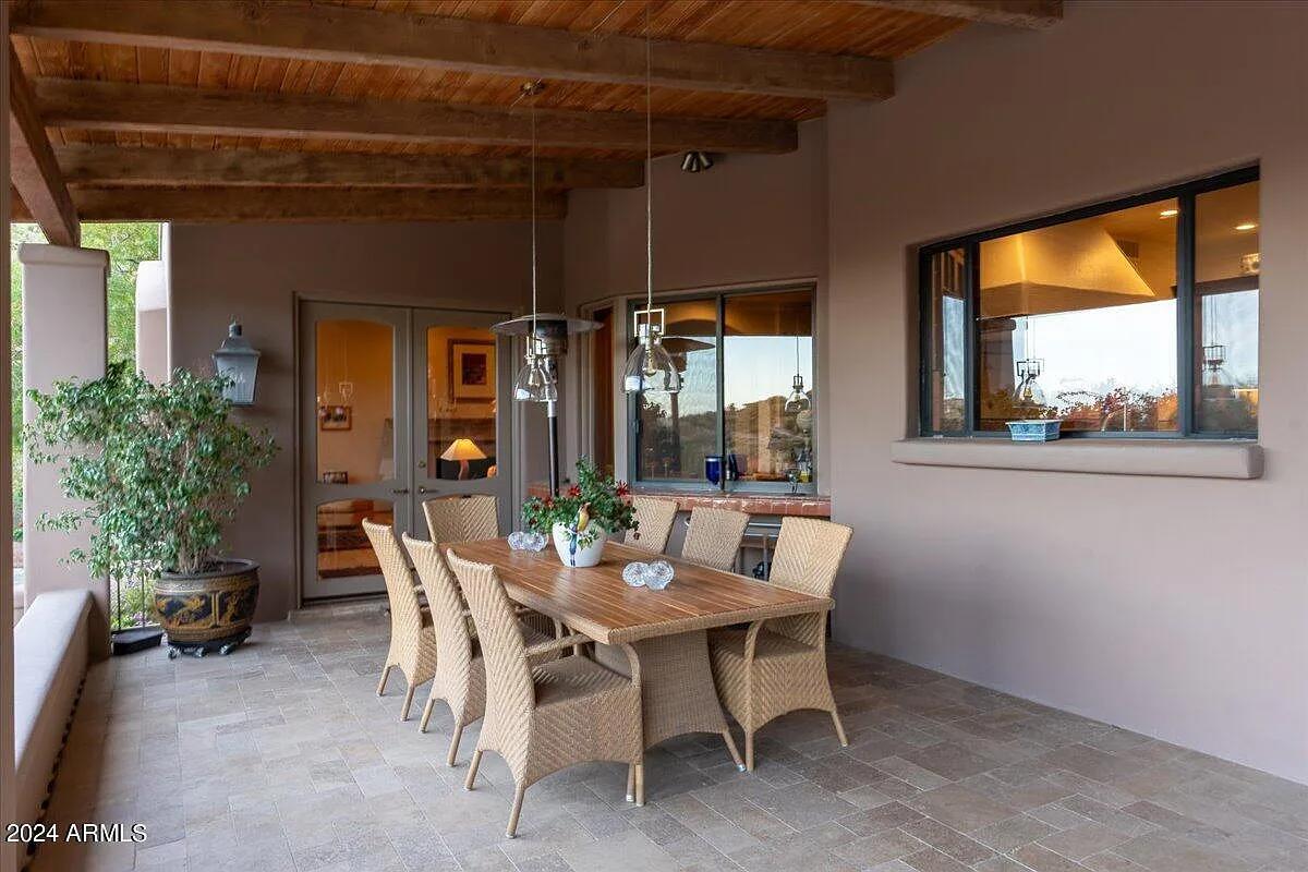 Outdoor dining area with a large wood table.