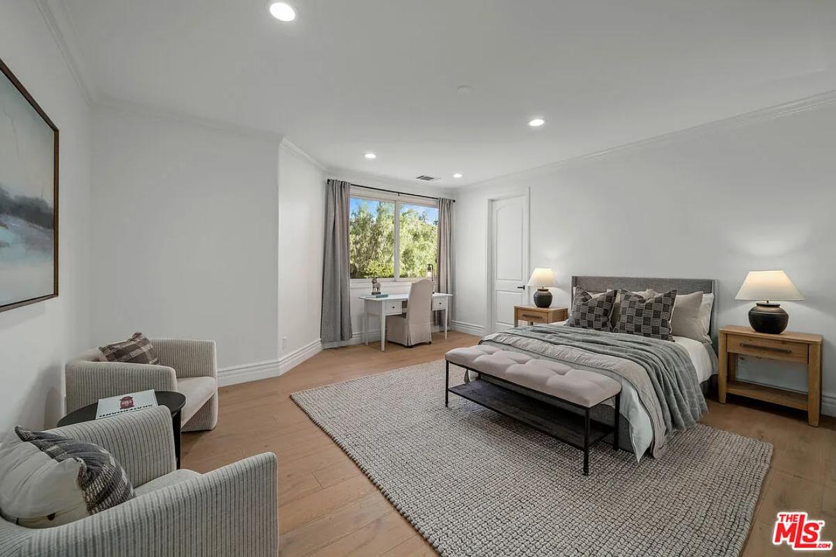 Bedroom with a large bed and hardwood floors.