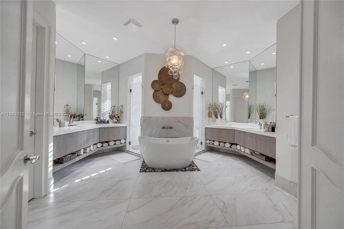 Bathroom with a custom-made vanity, a soaking tub and a walk-in shower.