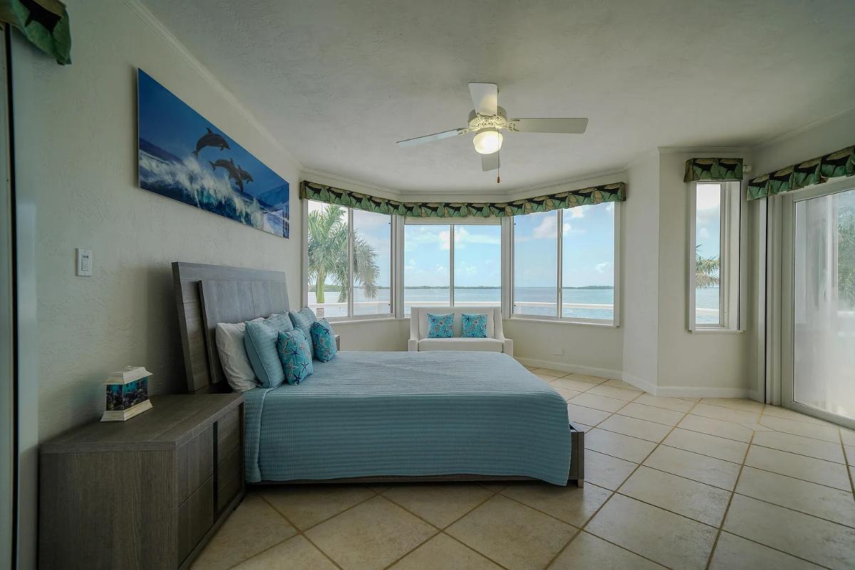 Bedroom with a large bed and glass windows.