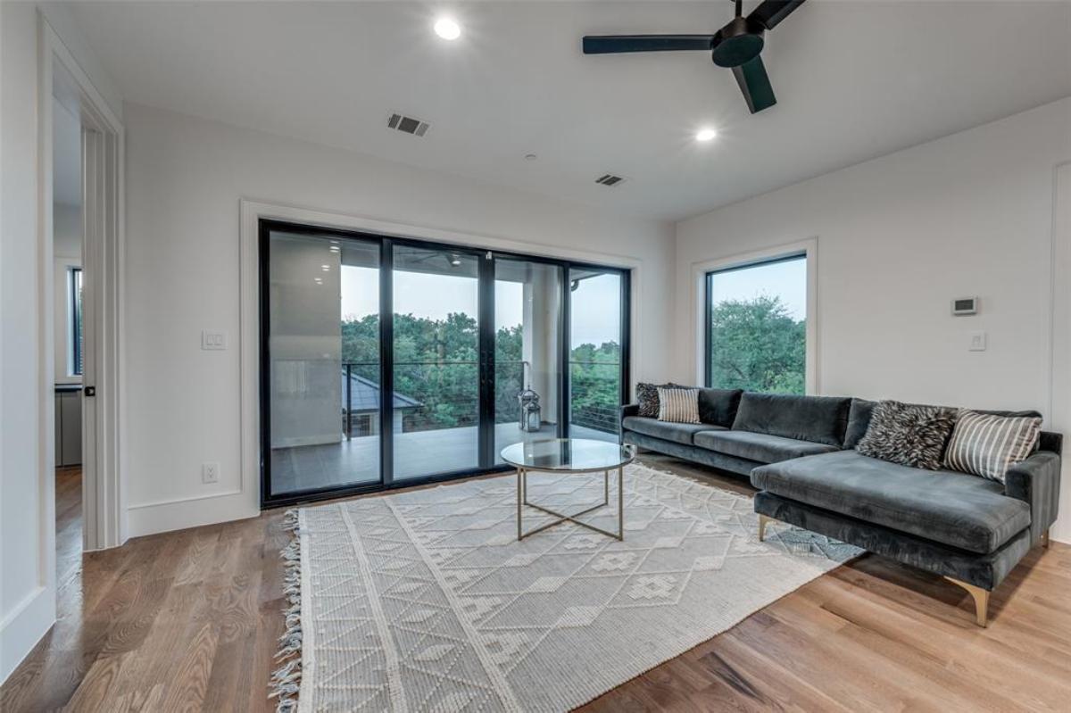 Family room with couches and hardwood floors.