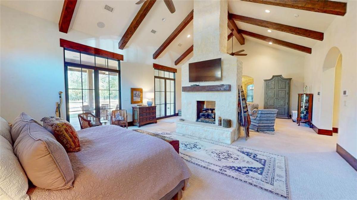 Bedroom with a large bed and carpet flooring.