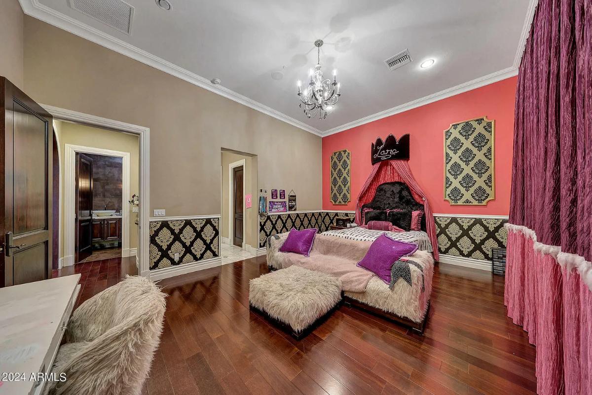 Bedroom with a large bed and hardwood floors.