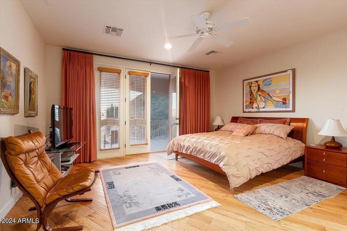 Bedroom with a large bed and hardwood floors.