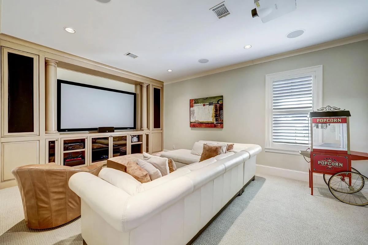 Home theater with carpet flooring and couches.