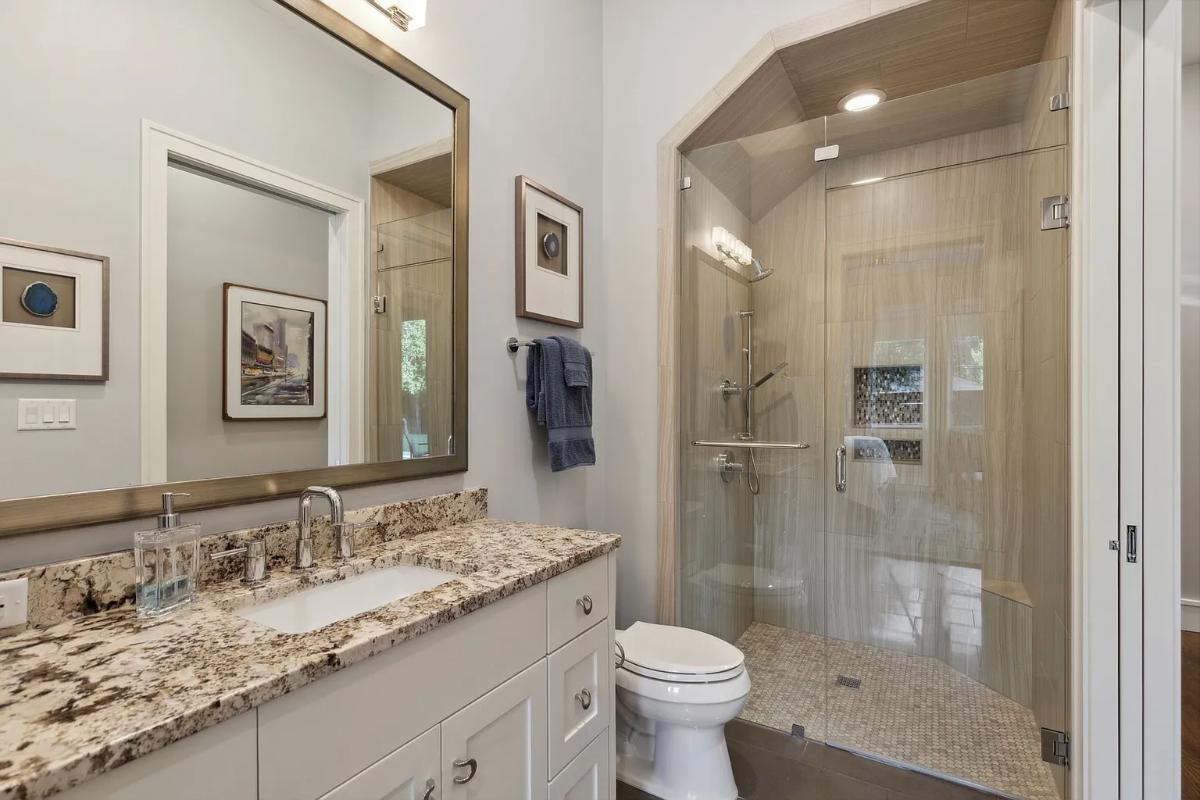 Bathroom with a sink, toilet and a walk-in shower.