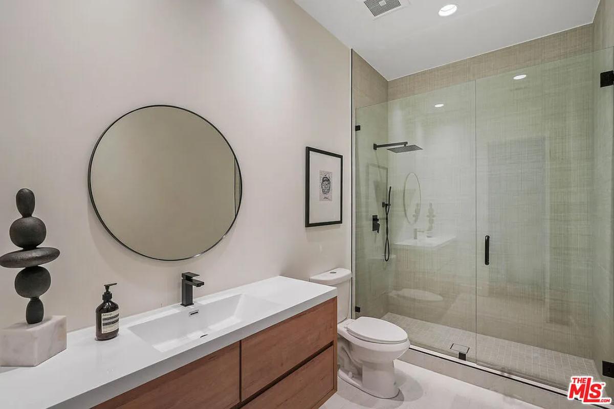 Bathroom with a sink, toilet and a walk-in shower.