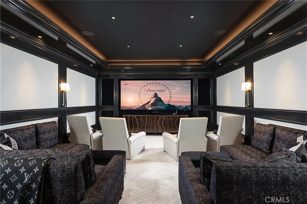 Home theater with carpet flooring and custom lighting.