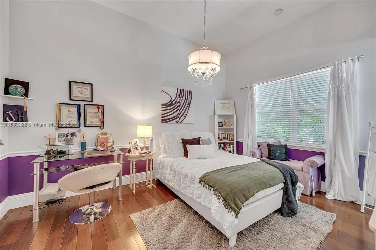 Bedroom with a large bed and hardwood floors.