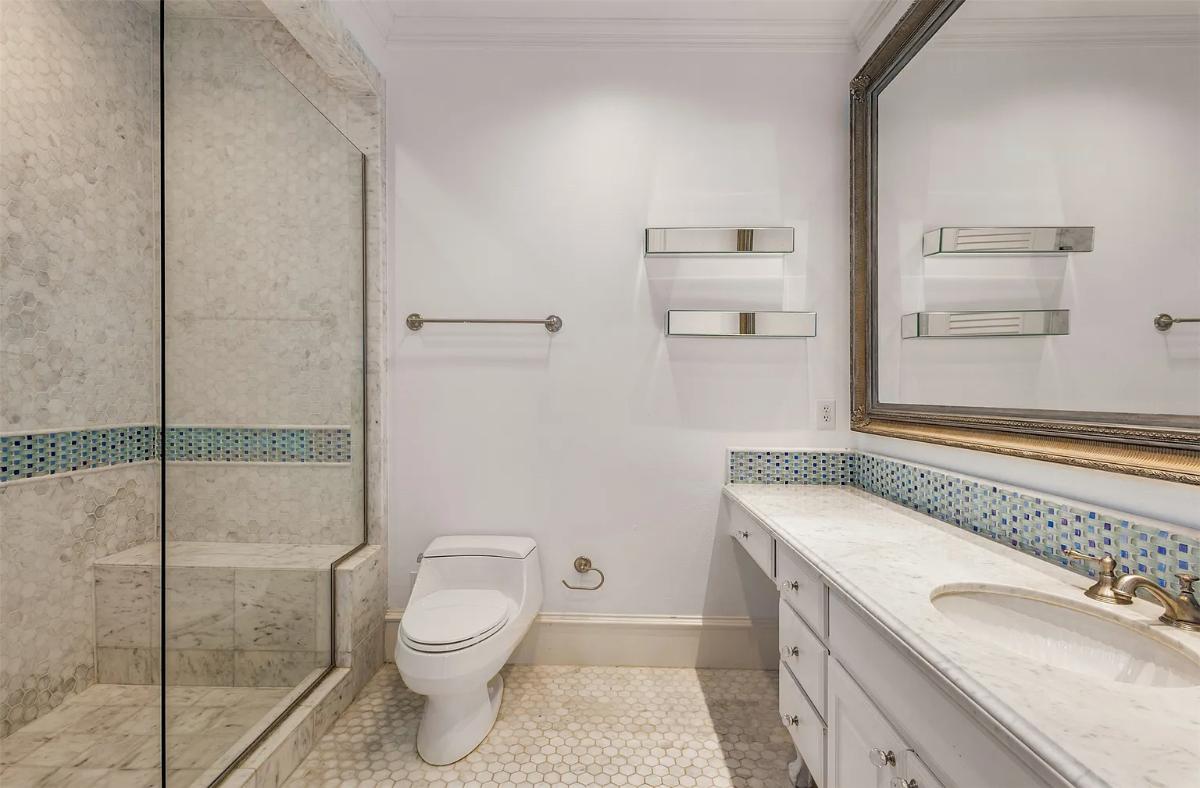 Bathroom with a sink, toilet and a walk-in shower.