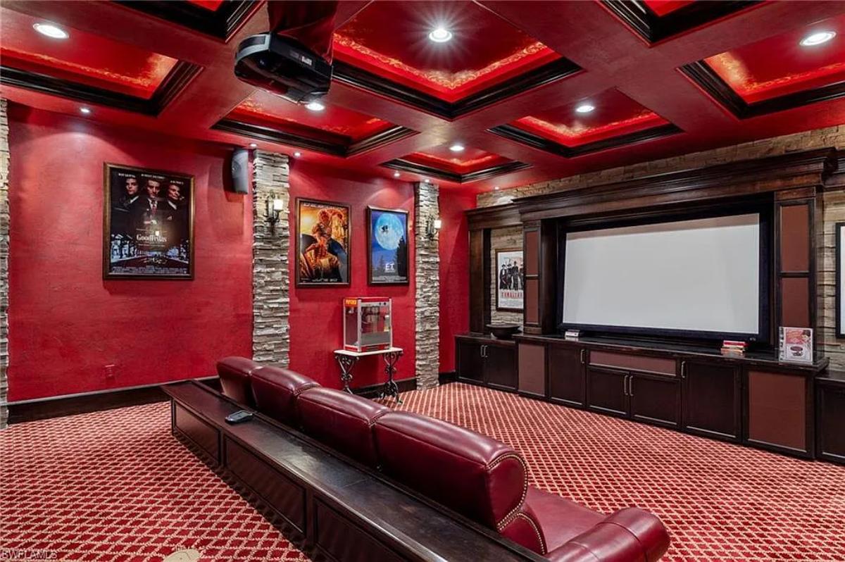 Home theater with carpet flooring and coffered ceilings.