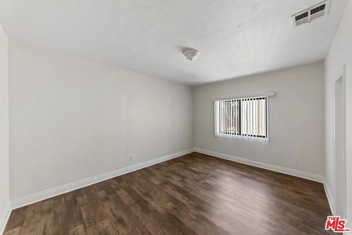 Bedroom with hardwood floors.