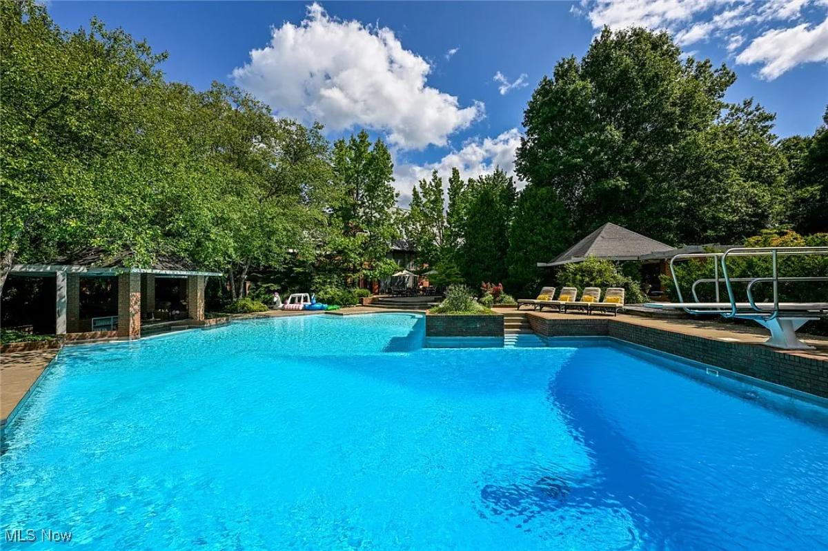 Pool with lounge chairs and a gazebo.