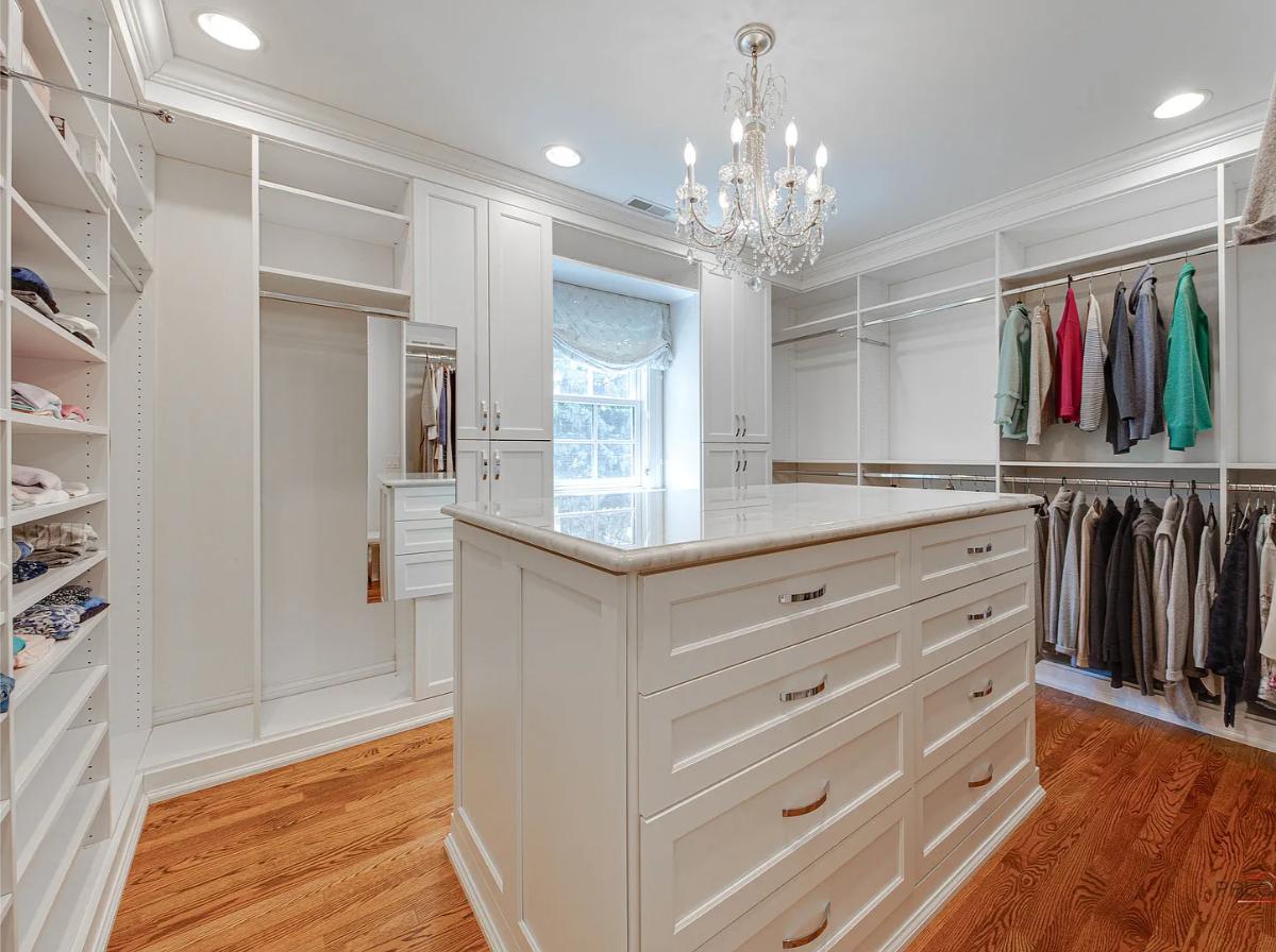 Walk-in closet with a chandelier.