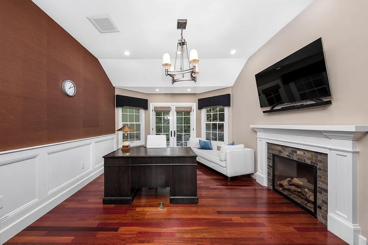 Home office with a fireplace.