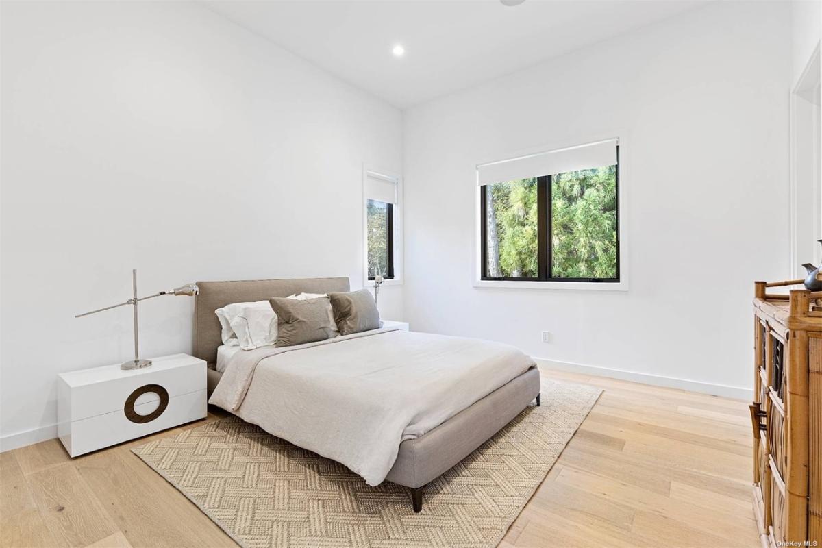 Bedroom with a large bed and hardwood floors.