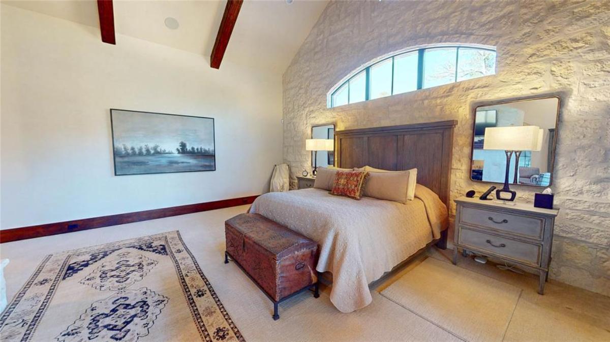 Bedroom with a large bed and carpet flooring.