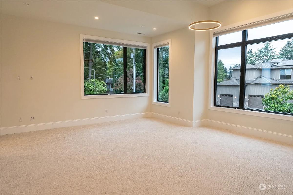 Bedroom with glass windows and carpet flooring.