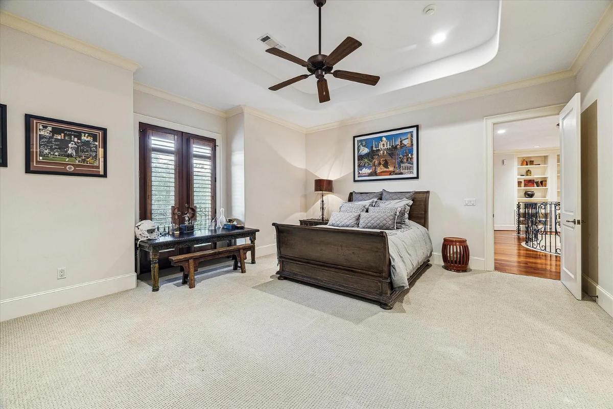 Bedroom with a large bed and carpet flooring.