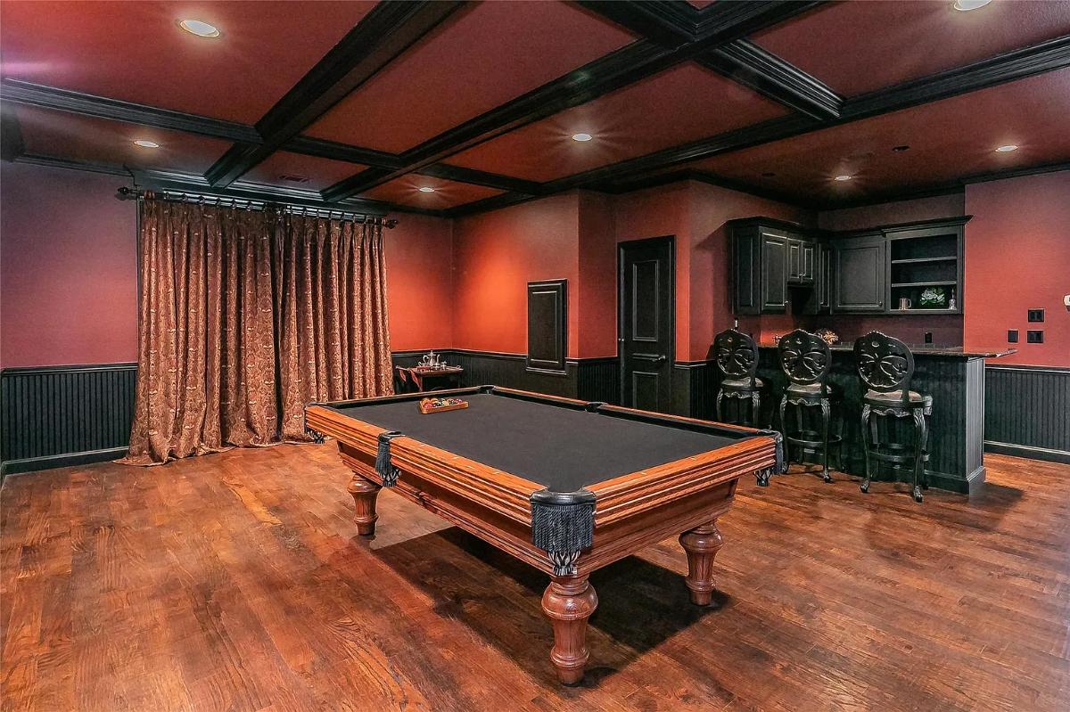 Recreation room with a billiards table and a bar.