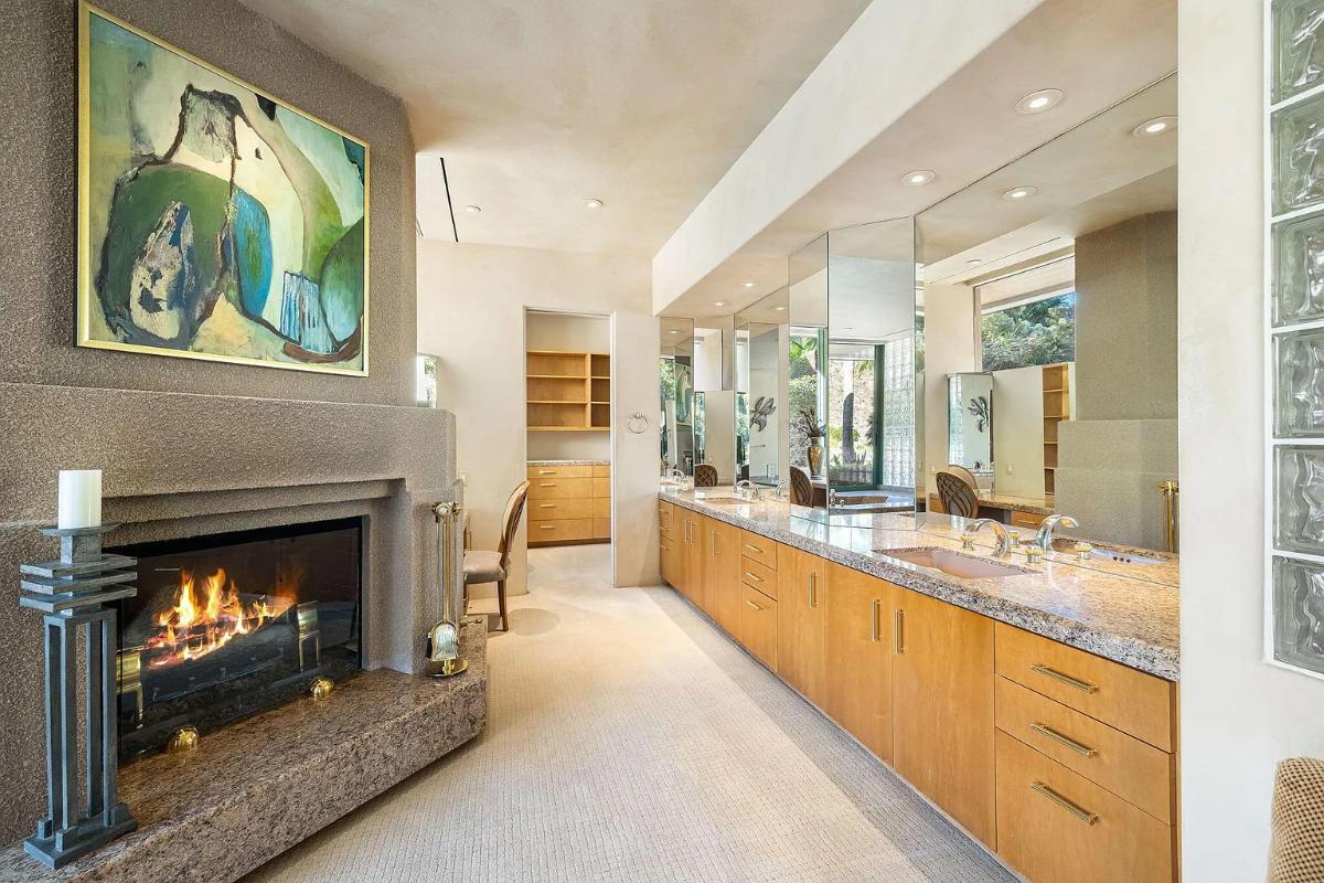 Bathroom with a custom-made vanity and a fireplace.