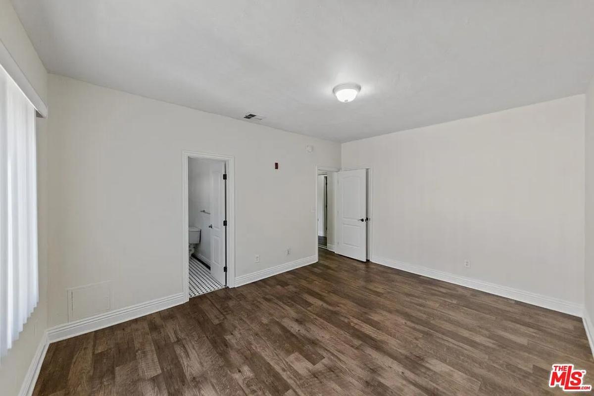 Bedroom with hardwood floors.